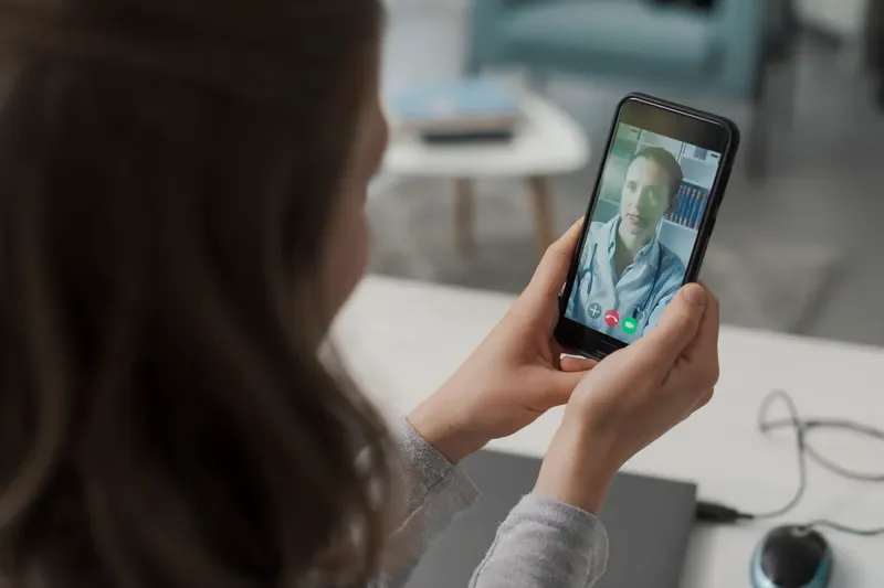 Man smiling and waving on a video call